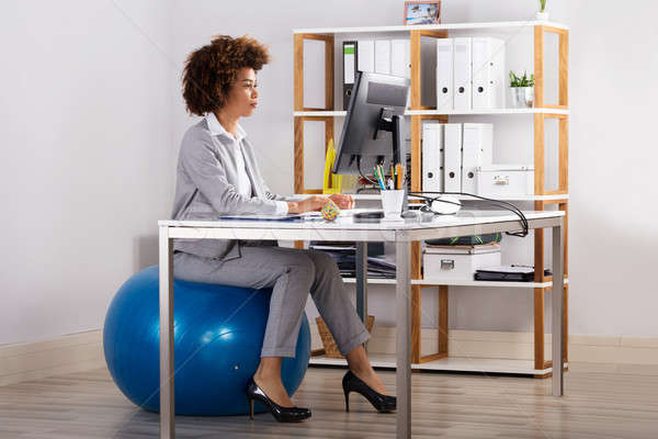 Stock photo: Young Businesswoman Working On Computer At Workplace