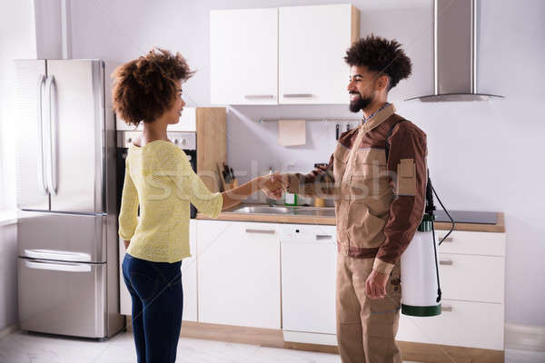 Pest Control Worker Shaking Hands With Woman Stock photo © AndreyPopov