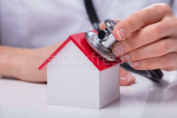 Woman Using Stethoscope To Check Model House Stock photo © AndreyPopov