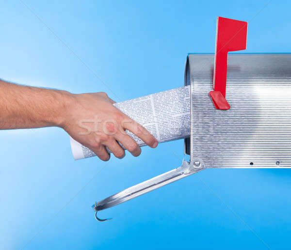 Man removing a newspaper from his mailbox Stock photo © AndreyPopov