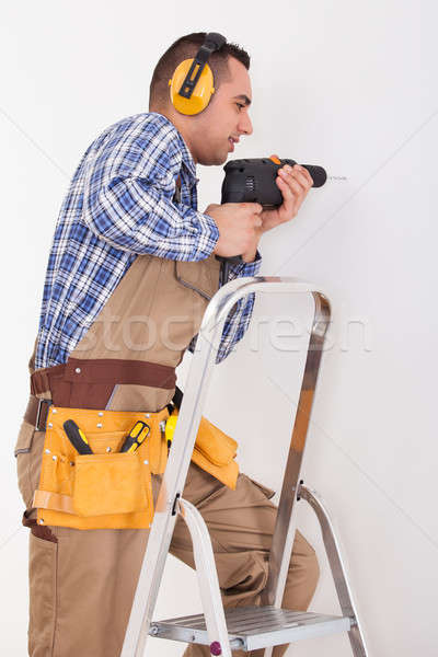 Repairman Drilling Hole In Wall Stock photo © AndreyPopov