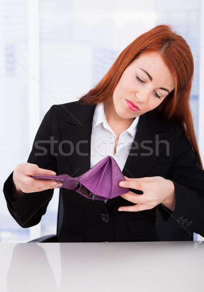 Upset Businesswoman Looking At Empty Wallet Stock photo © AndreyPopov