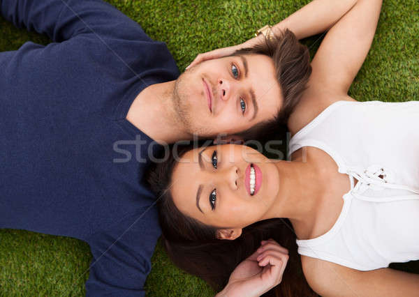 Young Couple Lying On Grass Stock photo © AndreyPopov