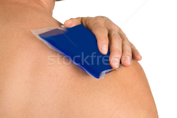 Hand With Cool Gel Pack On Shoulder Stock photo © AndreyPopov