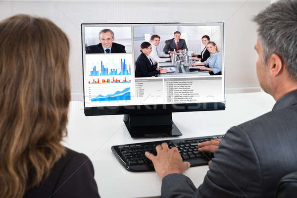 Two Businesspeople Participating In Video Conference Stock photo © AndreyPopov