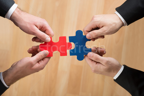 Cropped Image Of Businessmen Assembling Jigsaw Puzzle Stock photo © AndreyPopov