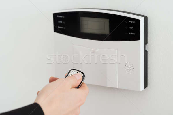 Woman Hand Using Remote To Operate Entrance Security System Stock photo © AndreyPopov