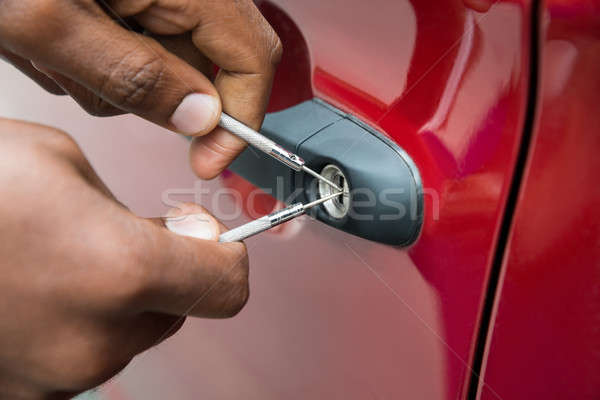 Person Hand Opening Car Door With Lockpicker Stock photo © AndreyPopov