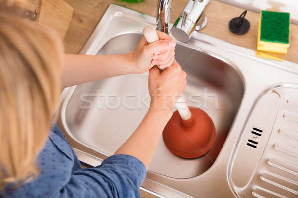 High Angle View Of Woman Using Plunger In Sink Stock photo © AndreyPopov