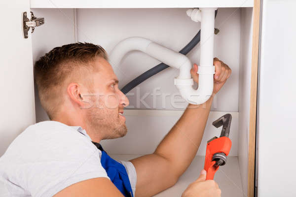 Male Plumber Repairing Sink Pipe Stock photo © AndreyPopov