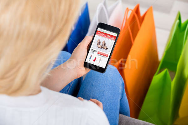 Stock photo: Woman Holding Mobilephone Shopping Online