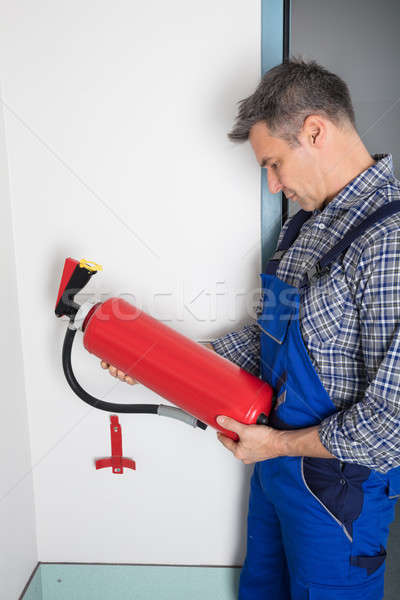 Professional Checking A Fire Extinguisher Stock photo © AndreyPopov