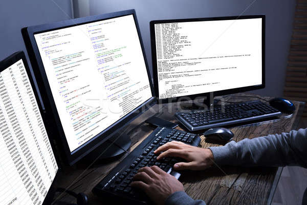 Hacker lop információ többszörös számítógépek oldalnézet Stock fotó © AndreyPopov