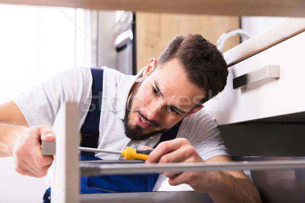 Stock photo: Male Carpenter Installing Drawer