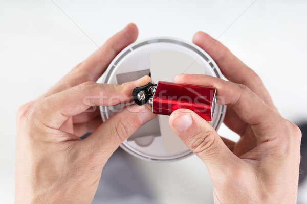 Person's Hand Inserting Battery In Smoke Detector Stock photo © AndreyPopov