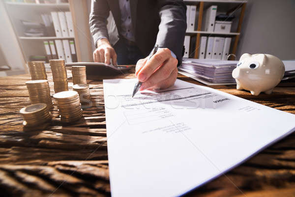 Close-up Of A Businessperson's Hand Signing Document Stock photo © AndreyPopov