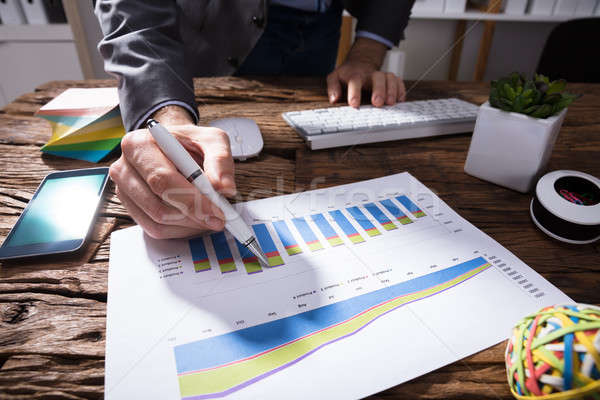 Businessperson Analyzing Financial Graph Stock photo © AndreyPopov