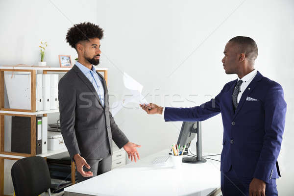 Dissatisfied Boss Giving Document To Employee Stock photo © AndreyPopov