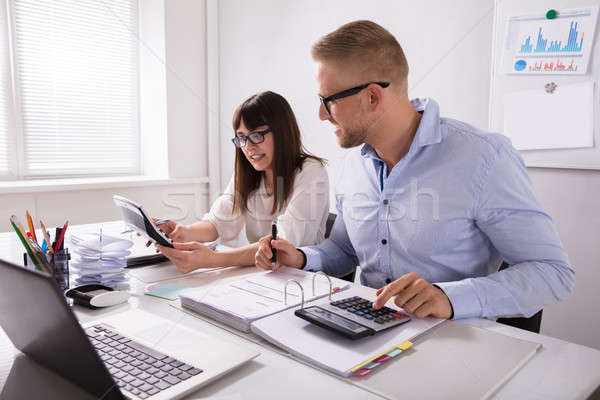 Two Businesspeople Calculating Invoice Stock photo © AndreyPopov