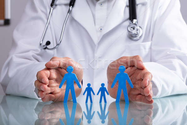 Doctor Protecting Family Figure Cutout Stock photo © AndreyPopov