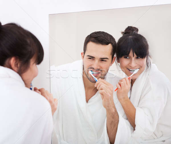 Young couple brushing teeth Stock photo © AndreyPopov