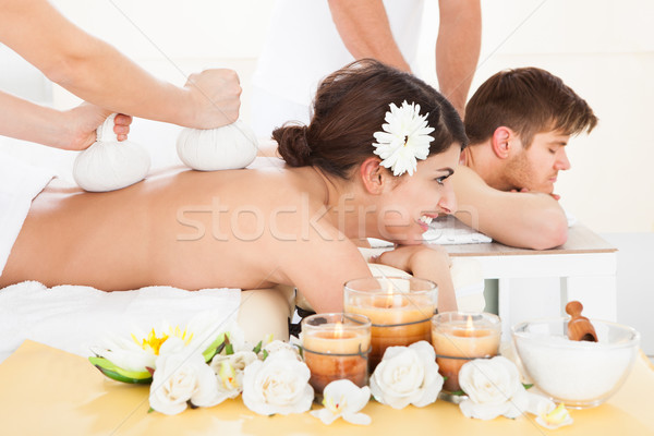 Woman Receiving Massage With Herbal Compress Stamps Stock photo © AndreyPopov