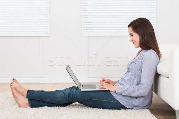Smiling Woman Using Laptop In House Stock photo © AndreyPopov