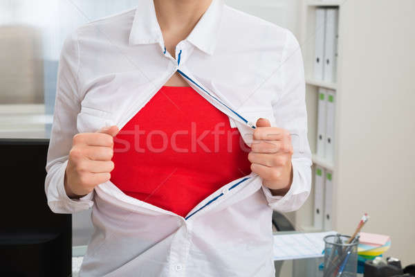 Businesswoman Tearing Her Shirt Showing Red Costume Stock photo © AndreyPopov