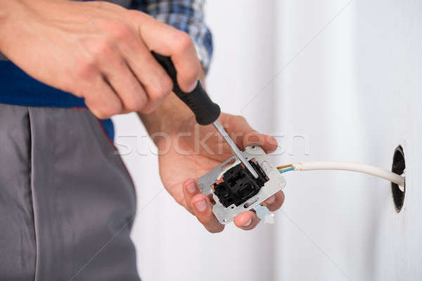 Elettricista mani presa primo piano muro Foto d'archivio © AndreyPopov