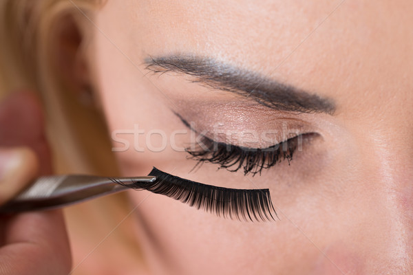 False Eyelashes Being Put On Woman's Eye Stock photo © AndreyPopov