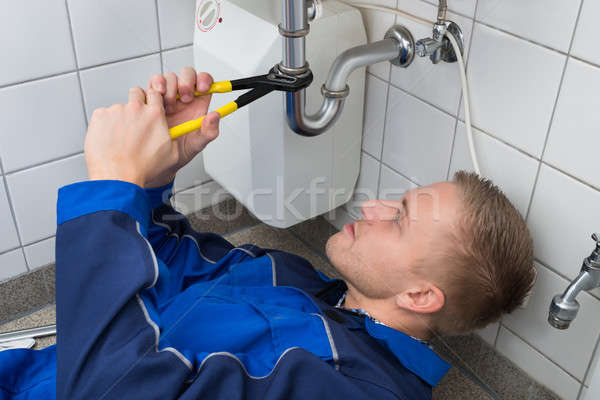 Vízvezetékszerelő javít mosdókagyló konyha fiatal férfi Stock fotó © AndreyPopov