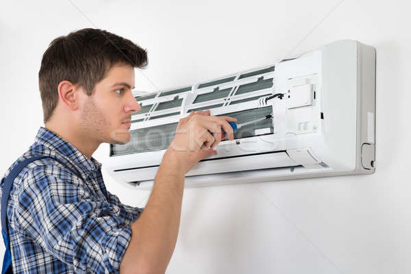 Stock photo: Technician Repairing Air Conditioner
