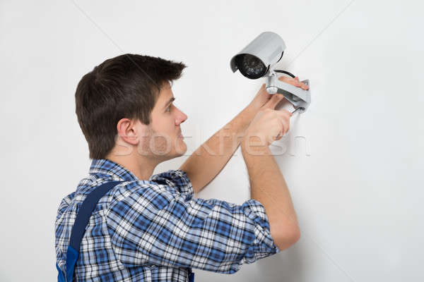 Technician Adjusting CCTV Camera Stock photo © AndreyPopov