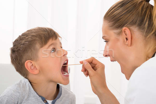 Doctor Examining Boy's Mouth Stock photo © AndreyPopov