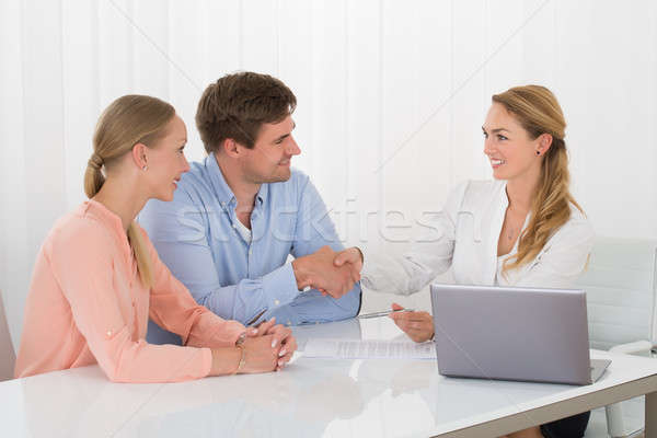 Consultant Shaking Hands With Couple Stock photo © AndreyPopov