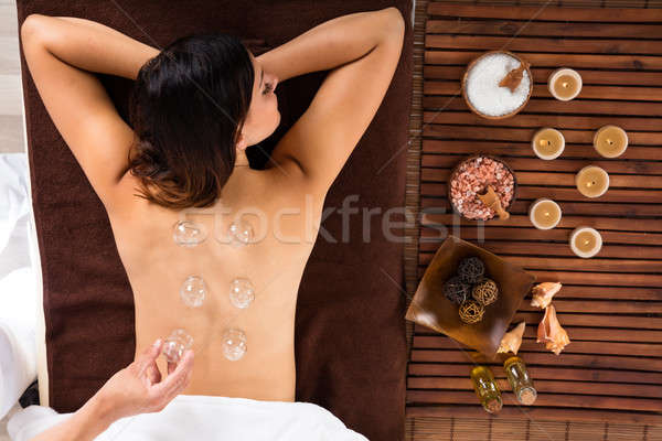 Relaxed Young Woman Receiving Cupping Treatment On Back Stock photo © AndreyPopov