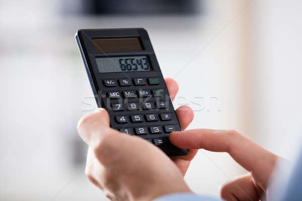 Közelkép személy tart számológép számítás munka Stock fotó © AndreyPopov