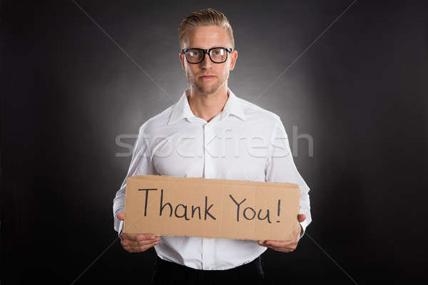 Man Holding Cardboard With Thank You Text Written On It Stock photo © AndreyPopov