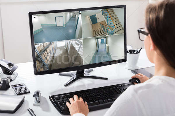 Businesswoman Watching CCTV Footage On Computer Stock photo © AndreyPopov