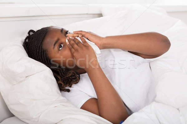 Mädchen Nase weht Gewebe african Bett Stock foto © AndreyPopov