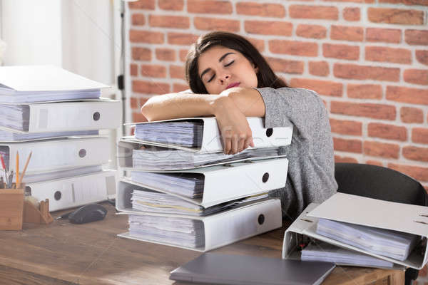 Businesswoman Sleeping On Folder Stacked In Office Stock photo © AndreyPopov