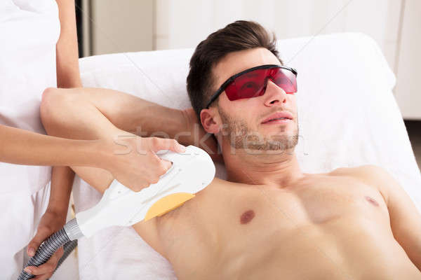 Man Having Underarm Laser Hair Removal Treatment Stock photo © AndreyPopov