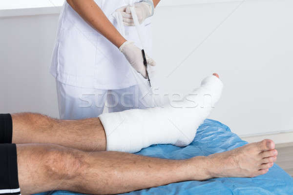 Doctor Tying Bandage On Person's Foot Stock photo © AndreyPopov