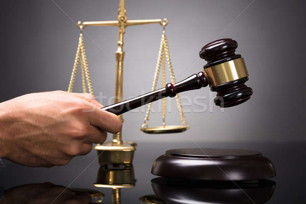 Judge Striking Gavel On Sounding Block Stock photo © AndreyPopov