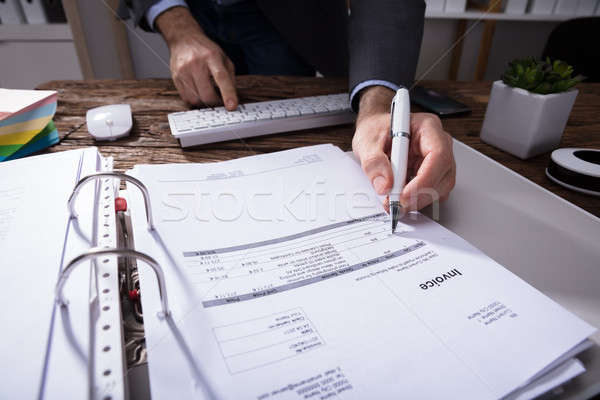 Businessperson Checking Bill Stock photo © AndreyPopov