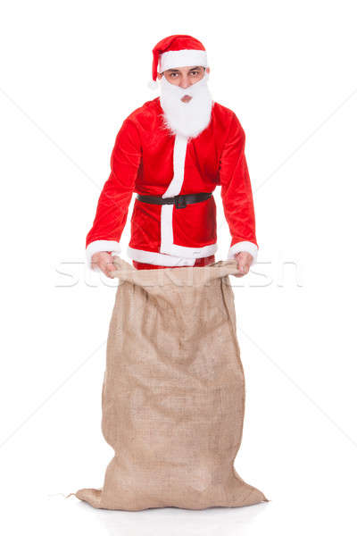 Santa Filling Bag With Gifts Stock photo © AndreyPopov
