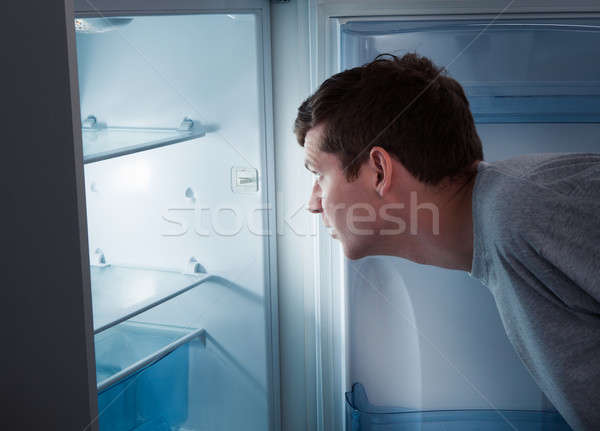 Hungry man looking in refrigerator Stock photo © AndreyPopov