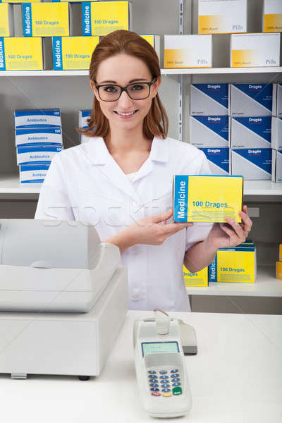 Female Pharmacist Showing Drug In Pharmacy Stock photo © AndreyPopov