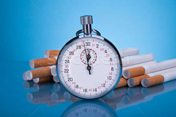 Cronógrafo foto cigarrillos gris reloj fondo Foto stock © AndreyPopov