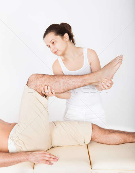 Woman Massaging Man's Foot Stock photo © AndreyPopov